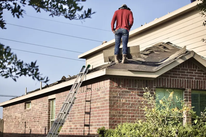 Professional roofer working on a residential roof in Potomac Falls